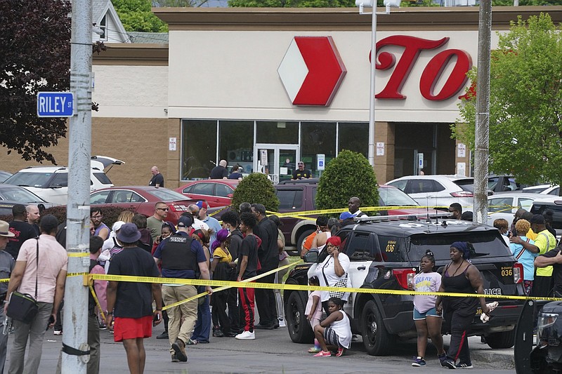 People gather outside a supermarket where several people were killed in a shooting Saturday in Buffalo, N.Y. Officials said the gunman entered the supermarket with a rifle and opened fire.
(AP/The Buffalo News/Derek Gee)