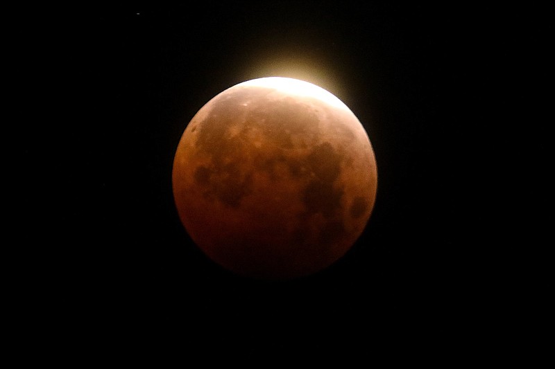 Light shines from a total lunar eclipse over Santa Monica Beach in Santa Monica, Calif., on May 26, 2021.
(AP/Ringo H.W. Chiu)