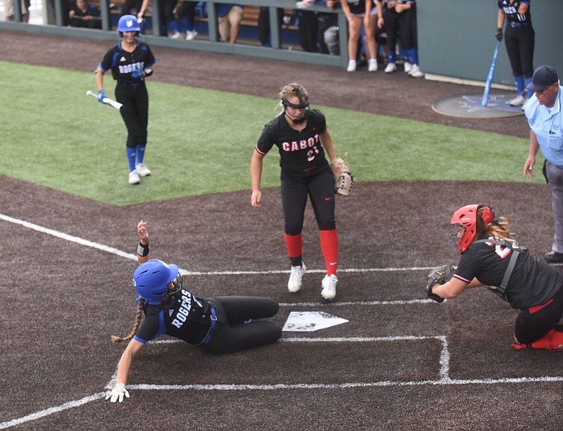 Lauryn Heinle slides into home Saturday to score the lone run for Rogers on a wild pitch in a 2-1 loss to Cabot in the semifinals of the Class 6A softball state tournament at Rogers. More photos at arkansasonline.com/515girls6a/.
(NWA Democrat-Gazette/Flip Putthoff)