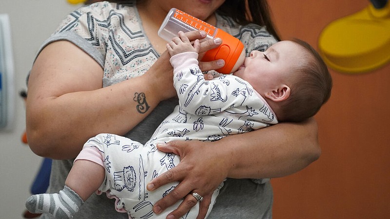 Elizabeth Amador bottle-feeds her daughter Destinee, 9 months, at the Ellis R. Shipp Public Health Center in West Valley City, Utah, on Thursday, May 12, 2022. A nationwide baby formula shortage has forced parents into online groups to swap and sell to each other to keep their babies fed. (AP/Rick Bowmer)