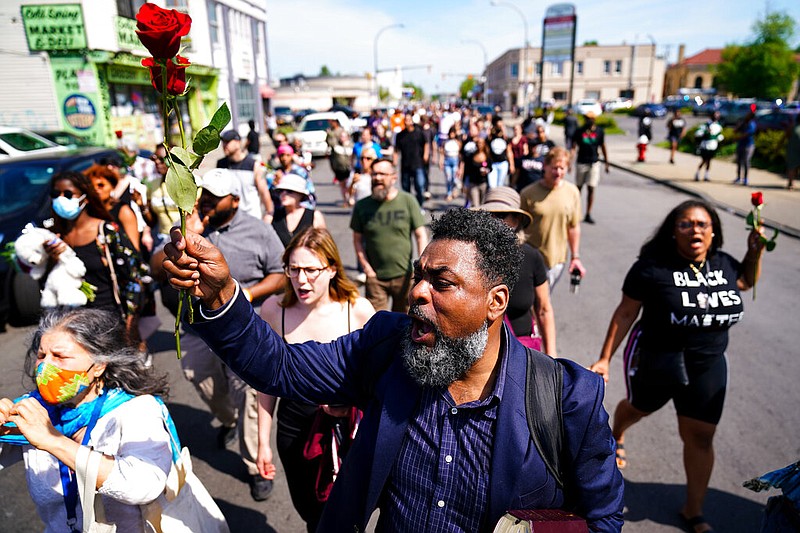 People march to the scene of a shooting at a supermarket in Buffalo, N.Y., Sunday, May 15, 2022. (AP/Matt Rourke)
