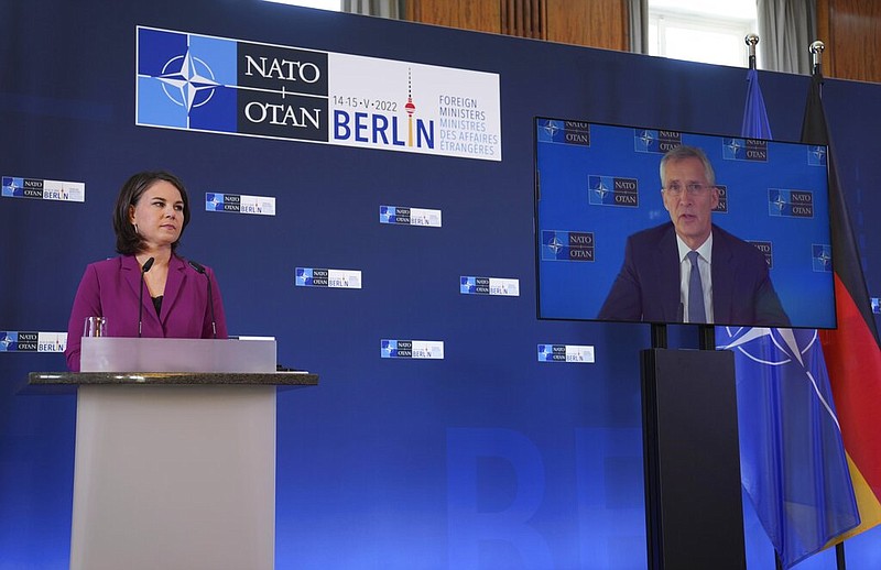 German Foreign Minister Annalena Baerbock listens to NATO Secretary General Jens Stoltenberg who speaks from a video screen during an informal meeting of the North Atlantic Council in Foreign Ministers' session in Berlin, Germany, Sunday, May 15, 2022. (AP/Michael Sohn)