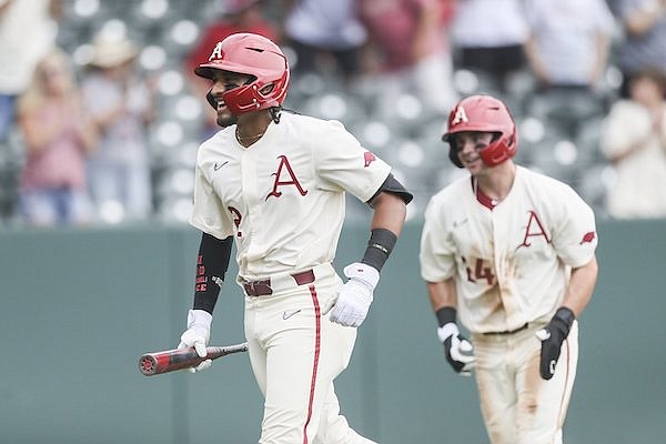 Arkansas shortstop Jalen Battles (3) is followed to the dugout by outfielder Braydon Webb (24) after Battles hit a two-run home run during a game against Vanderbilt on Sunday, May 15, 2022, in Fayetteville.