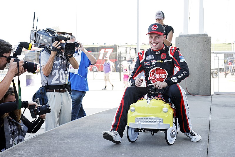 Christopher Bell celebrates with the speedway pole award Saturday after qualifying for the NASCAR Cup Series race at Kansas Speedway in Kansas City, Kan. (Associated Press)