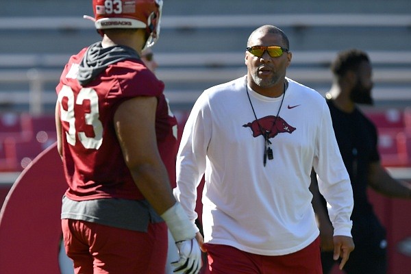 Arkansas defensive line coach Deke Adams directs his players Tuesday, March 15, 2022, during practice at Razorback Stadium in Fayetteville. Visit nwaonline.com/220316Daily/ for the photo gallery.