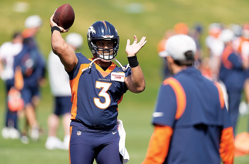 Broncos quarterback Russell Wilson takes part in drills in last month’s voluntary minicamp in Englewood, Colo. (Associated Press)