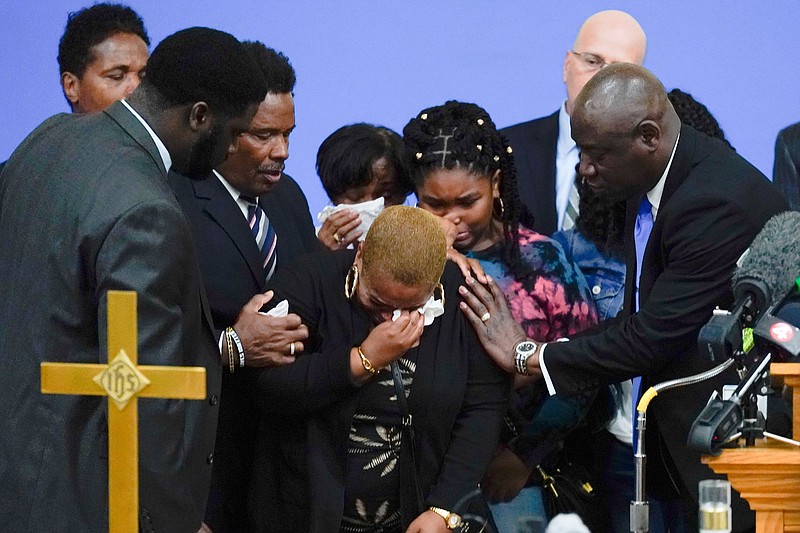 Tiffany Whitfield, a granddaughter of Ruth Whitfield, a victim of shooting at a supermarket, is overwhelmed with emotion during a news conference in Buffalo, N.Y., Monday, May 16, 2022. (AP Photo/Matt Rourke)