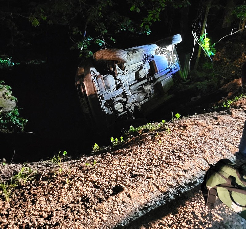 This photograph provided by the Osage County Sheriff's Office shows a car in a ravine off a private road Monday, May 16, 2022. The driver was found and rescued at approximately 11:15 p.m., culminating a search that began around 4 p.m.