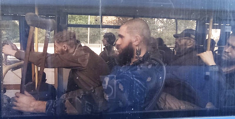 Ukrainian servicemen sit in a bus after they were evacuated from the besieged Mariupol's Azovstal steel plant, near a remand prison in Olyonivka, in a territory under the government of the Donetsk People's Republic's control, eastern Ukraine, Tuesday, May 17, 2022. (AP/Alexei Alexandrov)
