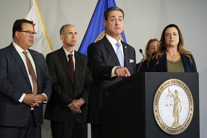 Orange County District Attorney Todd Spitzer, center, speaks during a news conference on Tuesday, May 17, 2022, in Santa Ana, Calif. Spitzer gave an update on the criminal charges in Sunday's shooting at Geneva Presbyterian Church. (AP Photo/Ashley Landis)