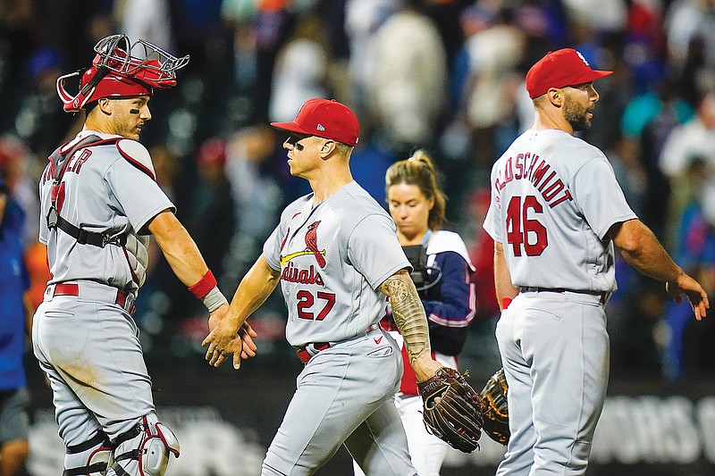 Tyler O’Neill (center) celebrates with Cardinals teammate Andrew Knizner after Tuesday night’s win in the second game of a doubleheader against the Mets in New York. (Associated Press)