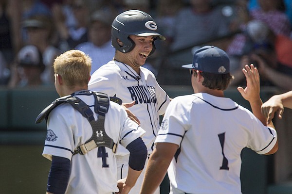 Greenwood's Peyton Holt (center) reacts after scoring a run during the first inning of the Class 6A baseball state championship game on Saturday, May 19, 2018, in Fayetteville.