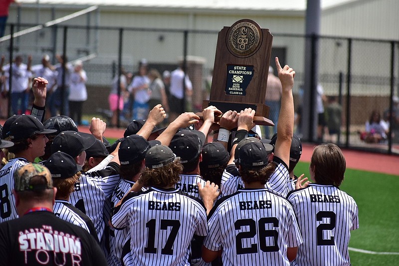 Woodlawn players hoist the 2A state high school baseball championship trophy after defeating Bigelow 7-2 on Thursday at Everett Field in Benton. 
(Pine Bluff Commercial/I.C. Murrell)