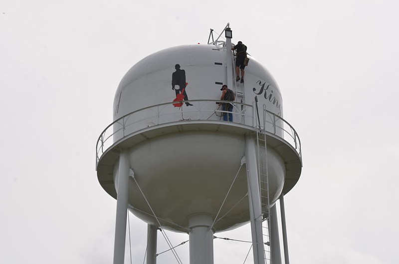 Workers repair a bullet hole in the Kingsland water tower on Thursday, May 19, 2022. (Special to The Commercial/Richard Ledbetter)