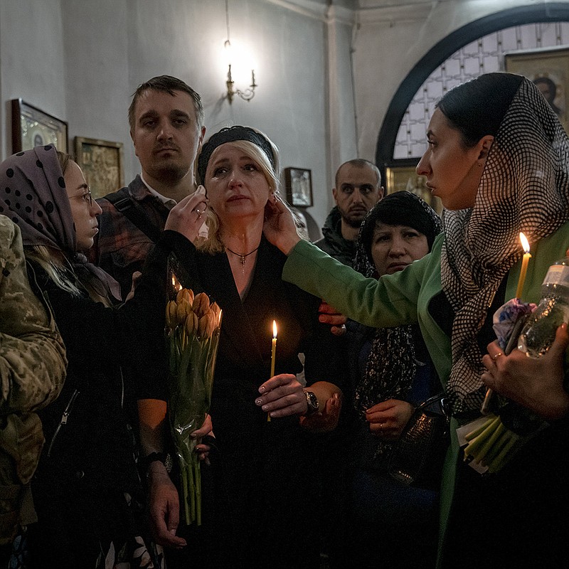 Nina Ponomarenko is comforted Friday by family members at the funeral for her son, Denys Ponomarenko, at St. Catherine’s Cathedral in Chernihiv, Ukraine. Denys Ponomarenko was a medic who was killed March 16 during shelling in Moschun. More photos at arkansasonline.com/ukrainemonth3/.
(The New York Times/Nicole Tung)