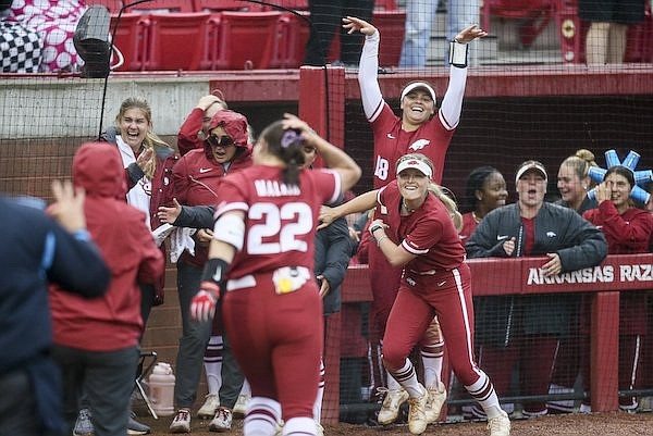 Arkansas players celebrate three runs during the sixth inning of an NCAA Tournament game against Oregon on Saturday, May 21, 2022, in Fayetteville.