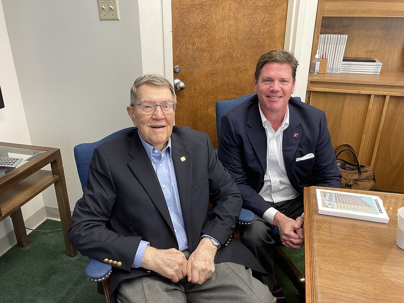 John Rush and his son Lee talk about working in the Simmons Trust Department, which is turning 100 next month. (Pine Bluff Commercial/Byron Tate)