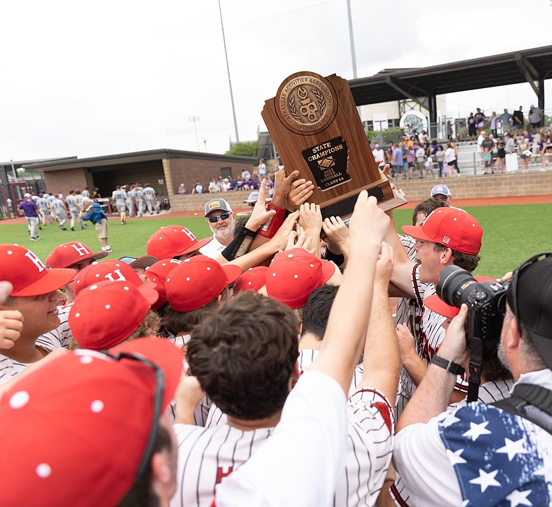 Harding players celebrate with their trophy after defeating Ashdown during the Class 3A State Baseball Championship Saturday at Benton Schools Athletic Complex, in Benton. (Arkansas Democrat-Gazette/Justin Cunningham)