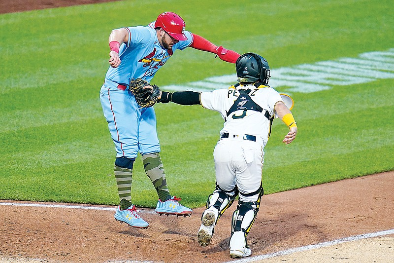 Juan Yepez of the Cardinals is tagged out by Pirates catcher Michael Perez as he attempts to score during the fifth inning of Saturday night’s game in Pittsburgh. (Associated Press)