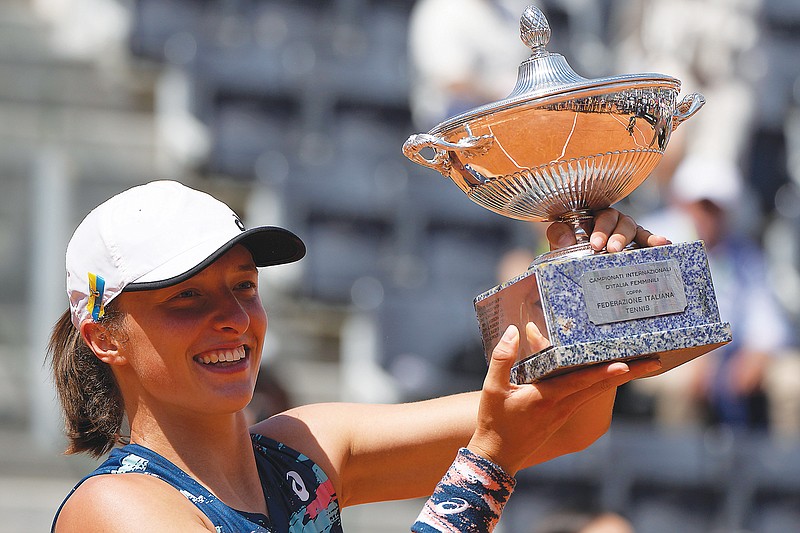 Iga Swiatek holds the trophy after winning the final against Ons Jabeur last week at the Italian Open in Rome. (Associated Press)