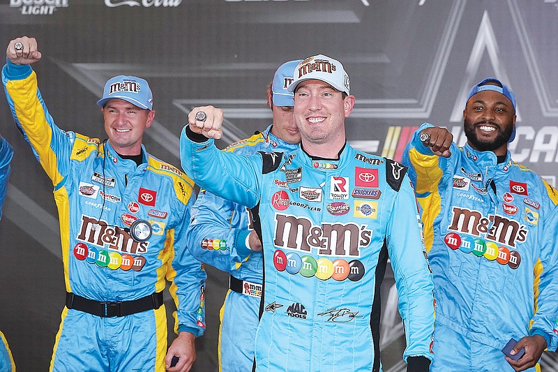 Kyle Busch and his crew show off their pole position rings after qualifications Saturday for the NASCAR All-Star race at Texas Motor Speedway in Fort Worth, Texas. (Associated Press)