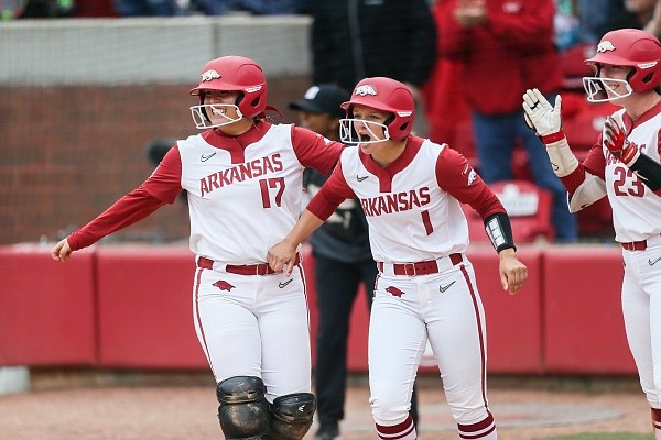 Arkansas Taylor Ellsworth (17) and infielder Raigan Kramer (1) react after a score, Sunday, May 22, 2022 during the sixth inning of the championship game of the Fayetteville Regional Softball Tournament at Bogle Park in Fayetteville. Check out nwaonline.com/220523Daily/ and nwadg.com/photos for the photo gallery.