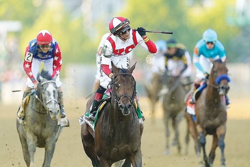 Jose Ortiz, atop Early Voting, celebrates Saturday after winning the Preakness Stakes at Pimlico Race Course in Baltimore. (Associated Press)