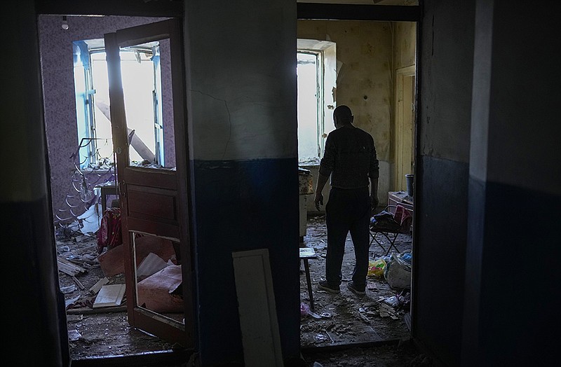 A resident gathers belongings from his damaged house Wednesday after a Russian attack in Pokrovsk in eastern Ukraine. Two rockets struck the town, injuring at least four people and damaging a row of houses. More photos at arkansasonline.com/ukrainemonth4/.
(AP/Francisco Seco)