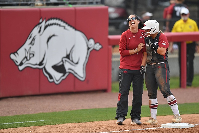 Arkansas Coach Courtney Deifel (left) shares a laugh with catcher Taylor Ellsworth during the Razorbacks’ NCAA Fayetteville Regional game Friday against Princeton. The Razorbacks open the best-of-3 super regional today against Texas.
(NWA Democrat-Gazette/Andy Shupe)