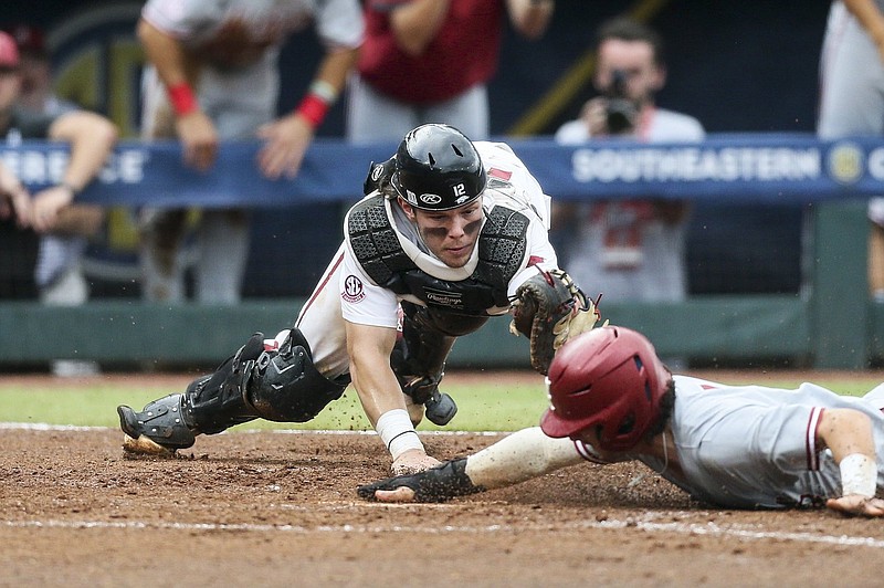 Arkansas catcher Michael Turner attempts to tag Alabama’s Caden Rose at home plate in the third inning of Wednesday’s SEC Tournament game at Hoover Metropolitan Stadium in Hoover, Ala. Rose scored on Drew Williamson’s sacrifice fly to give the Crimson Tide a 3-0 lead. Alabama went on to win 4-3 and put Arkansas in an elimination game today. More photos are available at arkansasonline.com/526alaua/
(NWA Democrat-Gazette/Charlie Kaijo)