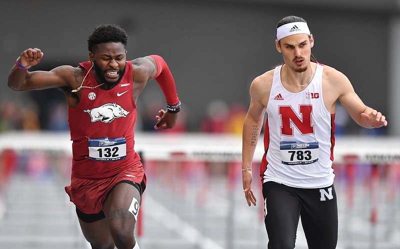 Matthew Lewis-Banks (left) of Arkansas crosses the finish line in the men’s 110-meter hurdles Wednesday during the NCAA Track and Field West Preliminaries at John McDonnell Field in Fayetteville. More photos are available at arkansasonline.com/526ncaatrack/
(NWA Democrat-Gazette/Andy Shupe)
