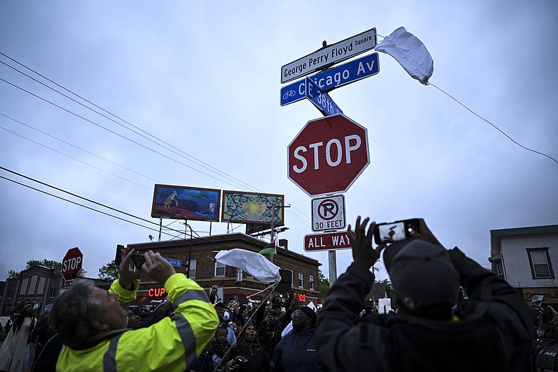 The George Perry Floyd Square street sign is unveiled Wednesday in Minneapolis before a vigil in Floyd’s memory. More photos at arkansasonline.com/526floydvigil/.
(AP/Star Tribune/Aaron Lavinsky)