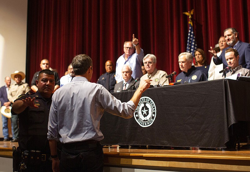 Beto O’Rourke (back to camera) interrupts Texas Gov. Greg Abbott during his news conference Wednesday in Uvalde, Texas. His action was met with a mixture of boos and cheers from the crowd.
(AP/Dario Lopez-Mills)