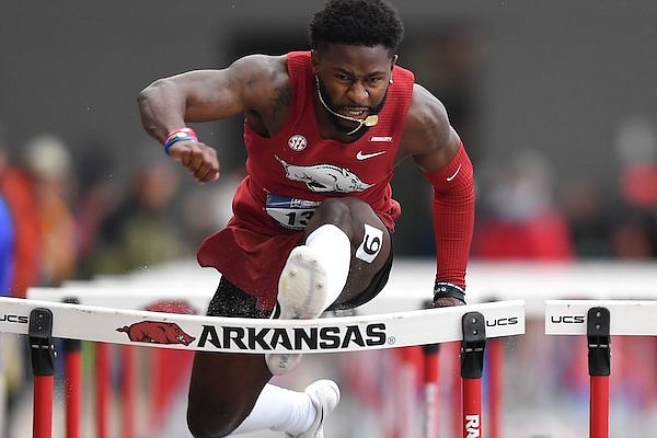 Arkansas' Matthew Lewis-Banks catches a hurdle Wednesday, May 25, 2022, in the 110-meter hurdles during the NCAA Track and Field West Preliminaries at John McDonnell Field in Fayetteville.