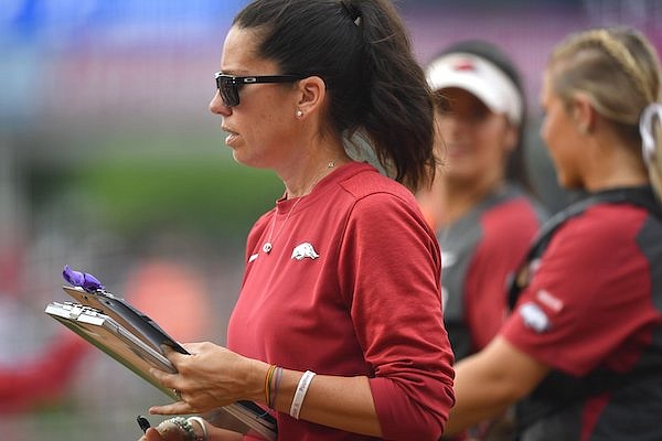 Arkansas coach Courtney Deifel speaks with her players Friday, May 20, 2022, during the fourth inning of the Razorbacks' 11-0 run-rule-shortened win over Princeton at Bogle Park in Fayetteville.