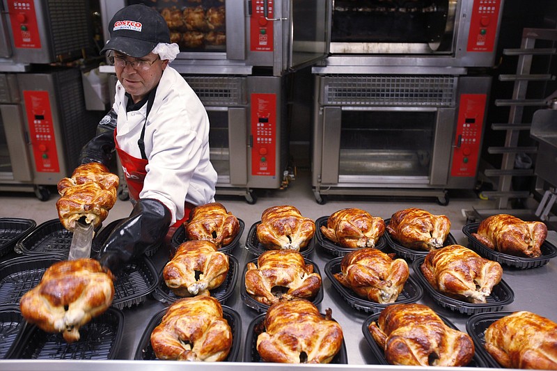 A Costco employee cooks chickens at a Costco in Mountain View, Calif., in this file photo. The U.S. economy shrank in the first three months of the year but consumer spending grew at a 3.1% annual pace from January through March.
(AP)