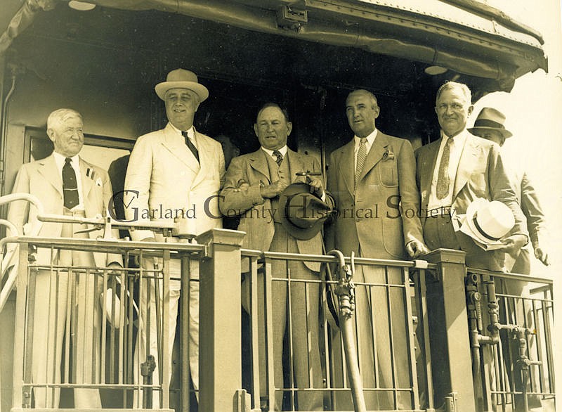 Arkansas Governor J. M. Futrell, left, President Franklin Delano Roosevelt, US Senator Joe T. Robinson, Mayor Leo P. McLaughlin, and AP&L founder Harvey Couch greet the welcoming crowd from the rear platform of the train. - Submitted photo