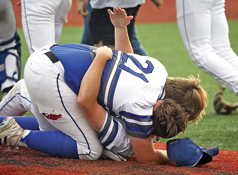 Russellville’s Logan Cinotto (21) hugs teammate Jesse Daniel after the final out of Wednesday’s Class 2 state quarterfinal game against Putnam County at South Callaway High School in Mokane. (Greg Jackson/News Tribune)