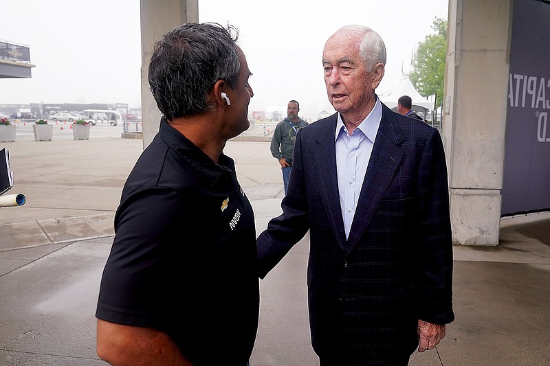 Roger Penske talks with Juan Pablo Montoya before a practice session last week at Indianapolis Motor Speedway in Indianapolis. (Associated Press)