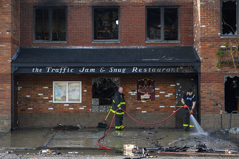 Detroit firefighters clean up in front of Traffic Jam and Snug Restaurant on Friday after an overnight fire.
(AP/Detroit News/Andy Morrison)