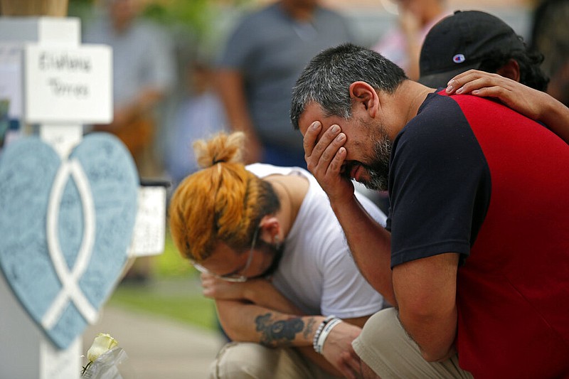 Vincent Salazar, right, father of Layla Salazar, weeps while kneeling in front of a cross with his daughter's name at a memorial site for the victims killed in this week's elementary school shooting in Uvalde, Texas, Friday, May 27, 2022. (AP/Dario Lopez-Mills)