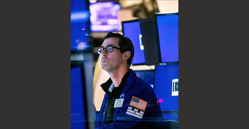 Specialist John McNierney watches stock prices rise Friday on the floor of the New York Stock Exchange.
(AP/New York Stock Exchange/Courtney Crow)