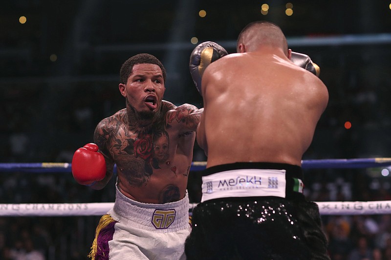 Gervonta Davis (left) throws a punch at Isaac Cruz during a recent WBC lightweight title boxing bout. Davis, who won his first title in Brooklyn, returns to the Barclays Center today for a headliner against Rolando Romero. The Showtime pay-per-view card marks the first big boxing event back in Brooklyn since the covid-19 pandemic started.
(AP/David Swanson)