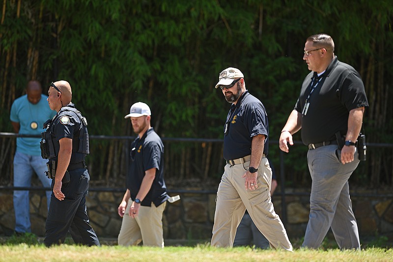 Investigators with the Little Rock Police Department and Arkansas State Police look around the scene of a homicide Saturday afternoon, May 28, 2022, on Fair Park Boulevard near Interstate 630. (Arkansas Democrat-Gazette/Staci Vandagriff)