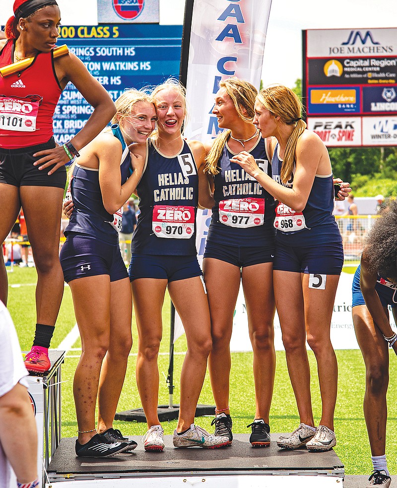 The Helias girls 4x200-meter relay team — (from left) Schyler Phillips, Kenadi Harrison, Isabelle Struemph and Mikah Edwards — celebrate on the award stand after taking second Saturday at Adkins Stadium. (Ken Barnes/News Tribune)