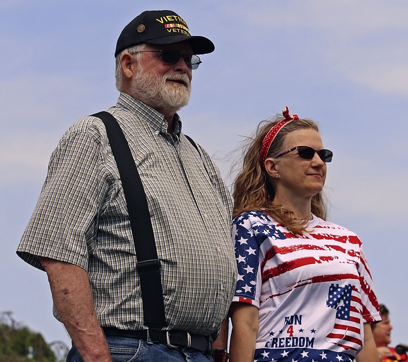 Citizens gather at a Memorial Day ceremony on Monday, May 30, 2022, at the Missouri State Capitol. Bob Lewbbert, left, and his wife Katie stand in recognition for those who served in the Army. Bob served for 36 years, as well as Katie's father who passed when she was 15. (Kate Cassady/News Tribune photo)