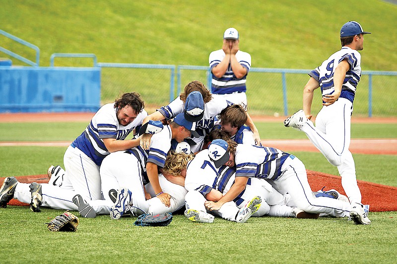 Russellville players form a dogpile near the pitcher’s mound after the final out of Tuesday’s Class 2 state championship game against Portageville at U.S. Ballpark in Ozark. (Greg Jackson/News Tribune)