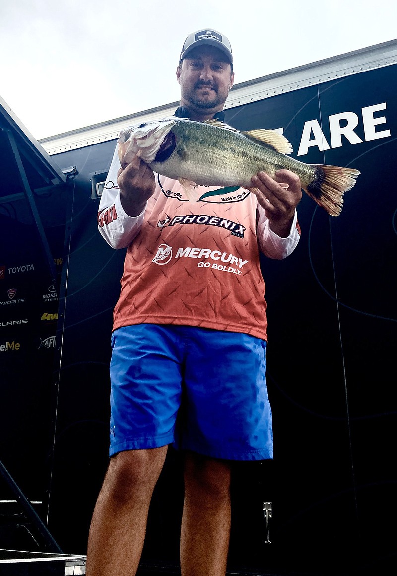 Connor Cunningham of Springfield, Mo., showcases the 6-pound bass that helped give him a comfortable lead after the first round of the Phoenix BFL All-American on Thursday at Lake Hamilton
(Arkansas Democrat-Gazette/Bryan Hendricks)