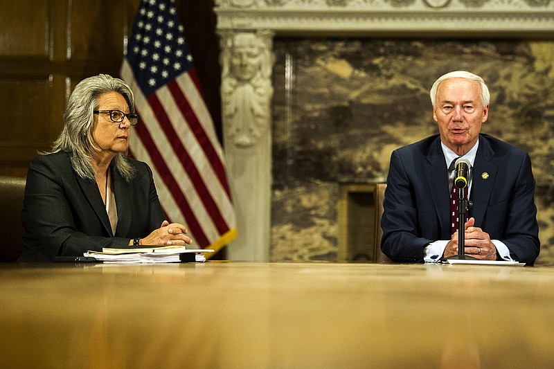 Dr. Cheryl May, director of the Criminal Justice Institute for the University of Arkansas System, and Gov. Asa Hutchinson talk with reporters Thursday about efforts to improve school safety. Hutchinson said he had asked May to reconvene the Arkansas School Safety Commission that met in 2018 for a review of policies and needs in the wake of recent school shootings.
(Arkansas Democrat-Gazette/Stephen Swofford)