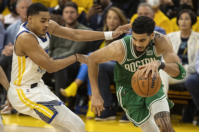 Boston Celtics forward Jayson Tatum drives toward the basket as Golden State Warriors guard Jordan Poole defends during the fourth quarter in Game 1 of the NBA Finals on Thursday in San Francisco. The Celtics erased a 15-point deficit to win 120-108.
(AP/San Francisco Chronicle/Strazzante)